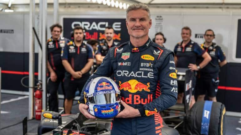 David Coulthard poses for a portrait in front of the RB7 on Bandra Bandstand  during the Red Bull Showrun in Mumbai, on March 12, 2023