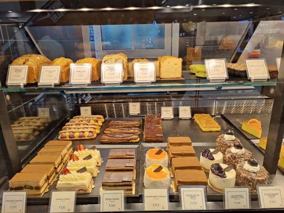 Slide along the confections counter, to check out the trail of pain au chocolat, strawberry tart, apple turnover, lemon tartlet, passion fruit gateaux, almond croissant and more at Paul, Delhi.