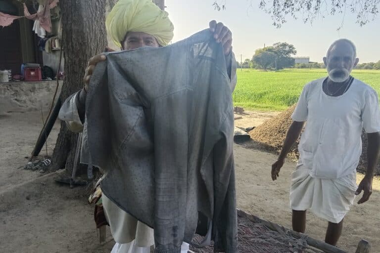 Residents of a village show their items covered in black dust which they claim is coming from the nearby factory which recycles tyre waste into low sulphur industrial fuel oil, carbon black, and steel scraps. Photo by Parul Kulshrestha.