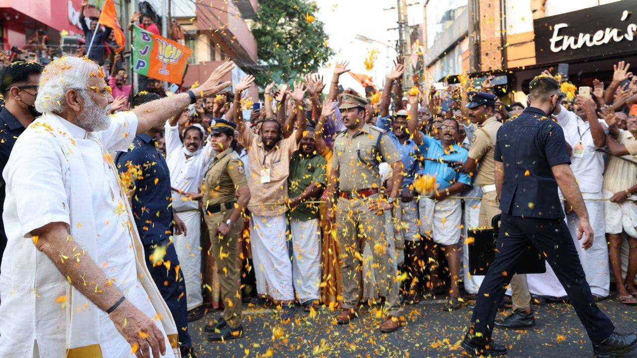 PM Modi was also seen shaking hands with people. The roadshow was markedly different from the PM's other roadshows, where he usually rides in an open-top vehicle. (Image: Twitter @narendramodi)
