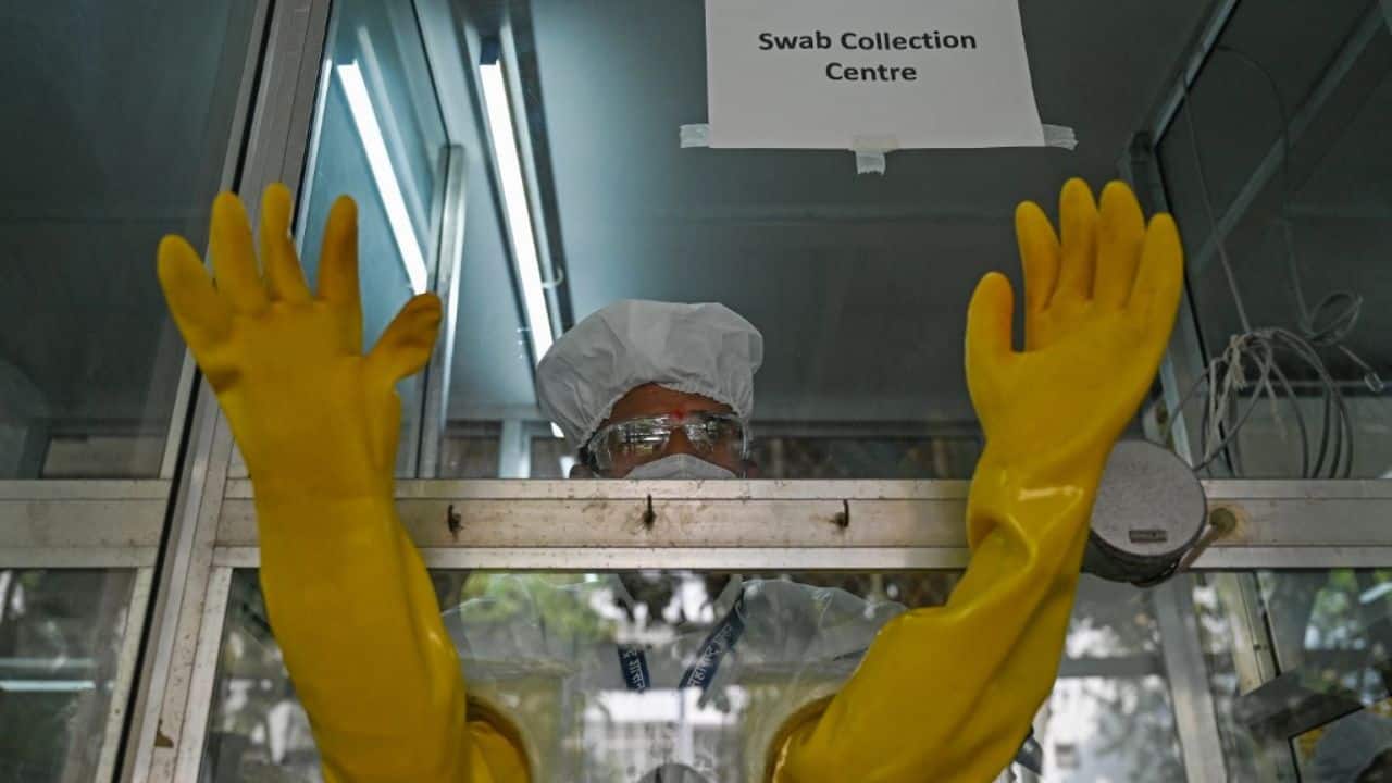 A health worker takes part in a mock drill to check preparations of Covid-19 facilities at a hospital in Mumbai. (Image: AFP)