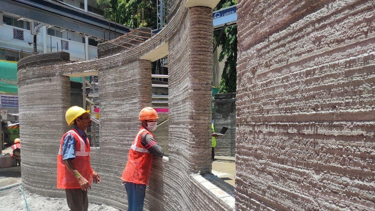 The process requires a delicate balance of concrete properties, including flowability, quick hardening for load-bearing capacity, green concrete status for inter- layer bonding, and sufficient strength to ensure successful printing. (Image: Souptik Datta/Moneycontrol) The process requires a delicate balance of concrete properties, including flowability, quick hardening for load-bearing capacity, green concrete status for inter- layer bonding, and sufficient strength to ensure successful printing. (Image: Souptik Datta/Moneycontrol)