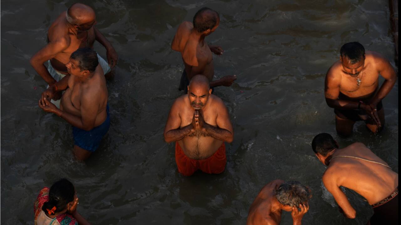 Devotees take holy dips and pray in the river Saryu on the occasion of Ramnavi festival, celebrated as the birthday of Lord Rama, in Ayodhya, Thursday, March 30.