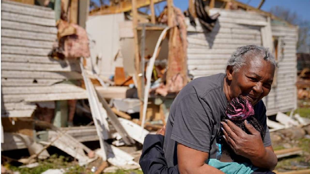 Woman embraces her great granddaughter in front of the wreckage of their home after seeing each other for the fist time since the monster storm. (Picture: Reuters) 