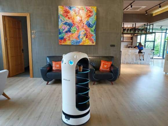 A food delivery robot in a coffee shop. (Photo via Unsplash)