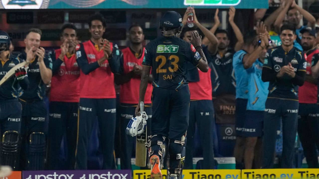 Teammates applaud Gujarat Titans' Sai Sudharsan (23) as he walks off the field after losing his wicket. Sudarshan smashed 96 in just 47 balls, with eight fours and six sixes. (Image: AP)