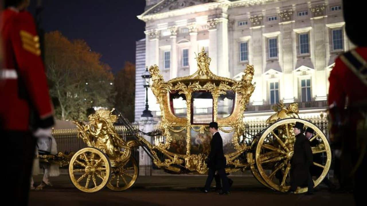 The Gold State Coach is ridden alongside members of the military during a full overnight dress rehearsal of the Coronation Ceremony of Britain’s King Charles and Camilla, Queen Consort in London, Britain, May 3. (Image: Reuters)