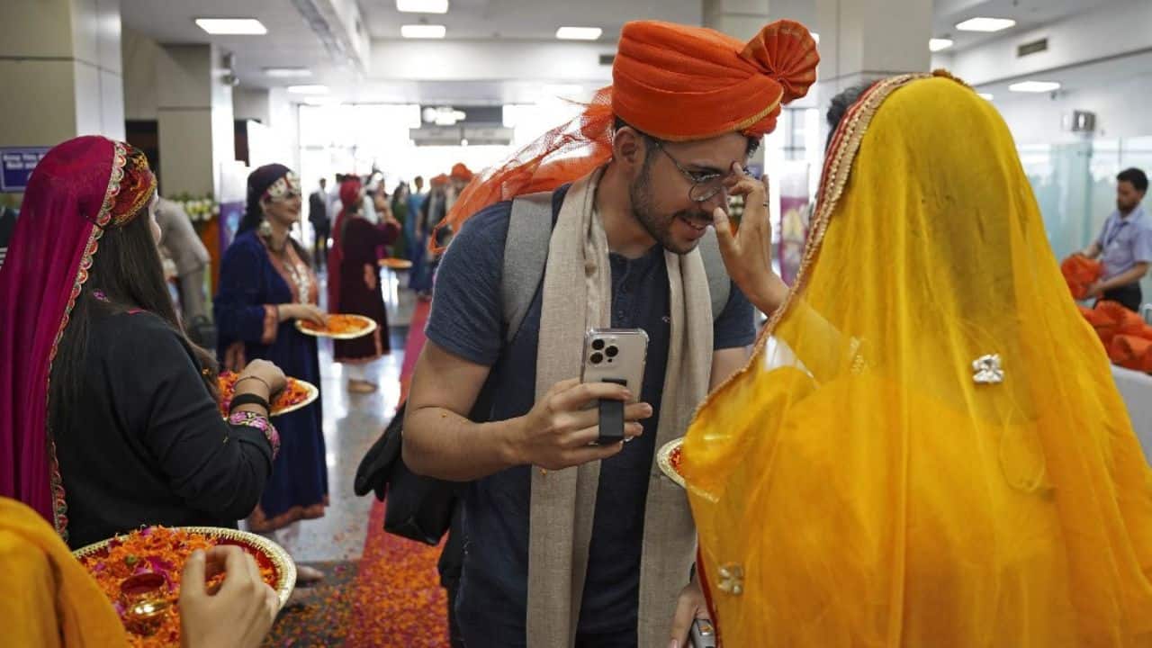 The delegations arrived at Sheikh-ul Alam International Airport in Srinagar as the mega event began on May 22. They were greeted by rows of lamp posts illuminated in the colours of the Indian national flag and billboards featuring the G20 logo. (Image: AFP)