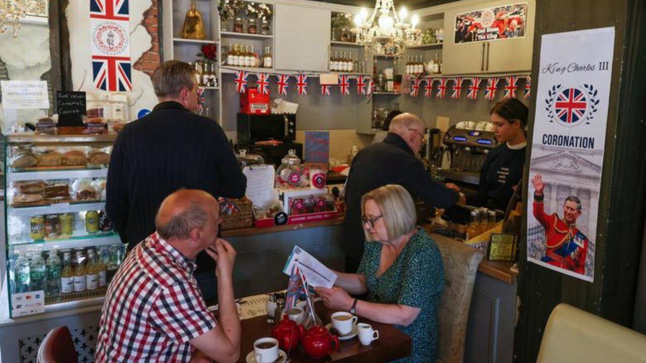 People sit in a cafe decorated for the Coronation of Britain's King Charles in Rochester, Britain, April 30. (Image: Reuters)