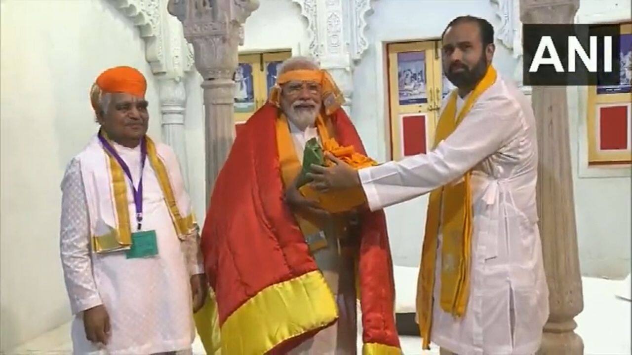 The Prime Minister visited Shrinathji Temple in Nathwara. The temple officials felicitated PM Modi. Modi will inaugurate three national highway projects, including 114-km long six lane Udaipur to Shamlaji section of NH-48, 110-km long widening and strengthening to 4 lane with paved shoulder of Bar-Bilara-Jodhpur Section of NH-25, and 47 km long two lane with paved shoulder section of NH 58E. (Image: ANI video grab)
