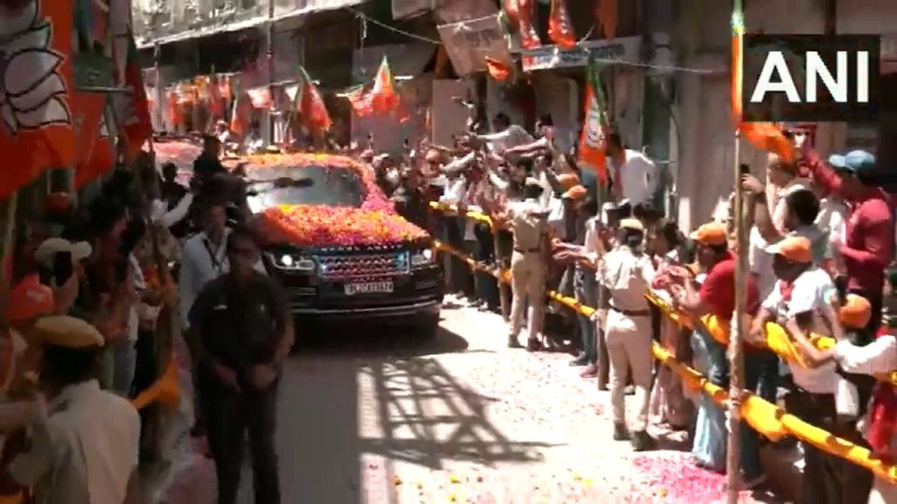 People showered flower petals on PM Modi's car as he arrives in Rajasthan's Nathdwara. The focus of the projects to be launched by the prime minister will be on bolstering infrastructure and connectivity in the region, the PMO said, adding road and railway works will facilitate the movement of goods and services, boosting trade and commerce and improving the socio-economic conditions of the people in the region. (Image: ANI video grab)