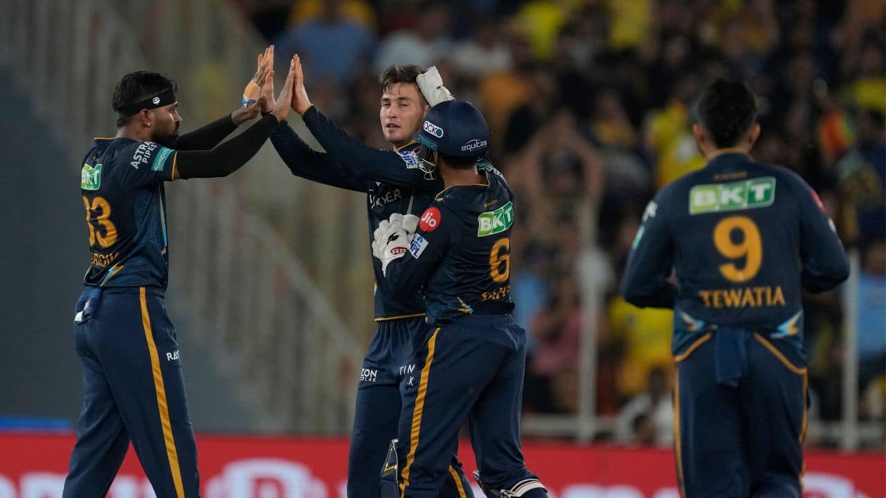 Gujarat Titans' Noor Ahmad, second left, celebrates with teammates the dismissal of Chennai Super Kings' Devon Conway during the Indian Premier League final cricket match between Chennai Super Kings and Gujarat Titans. (Image: AP)