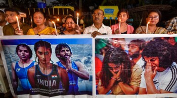 Members of 'Jatiya Mahila Shakti, the women's wing of Assam Jatiya Parishad, take out a candle march in support of the wrestlers (PTI Photo)