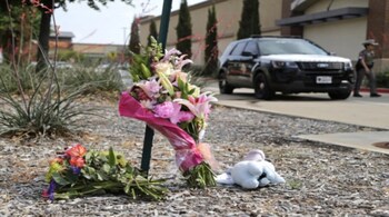 Flowers and a stuffed animal are left at the scene the day after a shooting at Allen Premium Outlets on May 7, 2023 in Allen, Texas. (AFP Photo)
