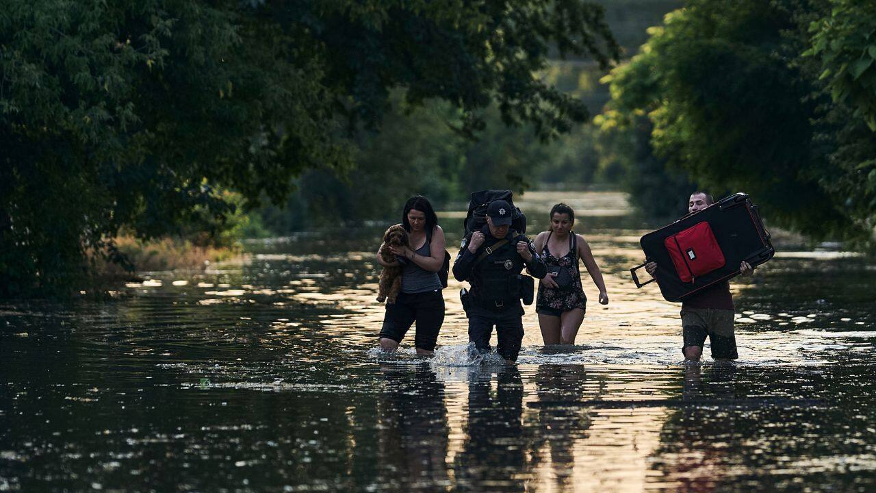 Residents sloshed through knee-deep waters in inundated homes as videos posted on social media showed scenes including rescue workers carrying people to safety and what looked like the triangular roof of an entire building that had been uprooted drifting downstream. Footage taken from the air showed waters filling the streets of Russian-controlled Nova Kakhovska on the eastern side of the river. (Image: AP)