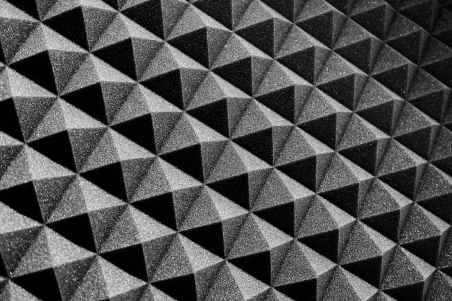 Acoustic foam. Building customized panels or diffusers can be a cost-effective solution.