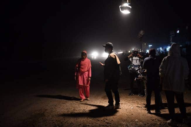 Zarrar Kahn instructing Ramesha Nawal's Mariam during the shoot of 'In Flames' in Karachi. (Image courtesy Citylights Media)