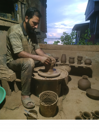Glazed pottery maker Mohammad Umar Kumar at work at his father's decades' old shop in Srinagar.