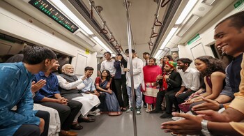 PM Narendra Modi interacts with passengers in Delhi Metro on his way to attend the centenary celebrations of the University of Delhi, in New Delhi (PTI Photo)