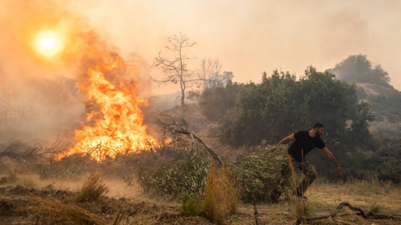 The fires, spurred by a sweltering heat wave that blanketed the country, triggered a huge evacuation of residents and tourists on the island last weekend as forests burned for a week. (Source: AP)