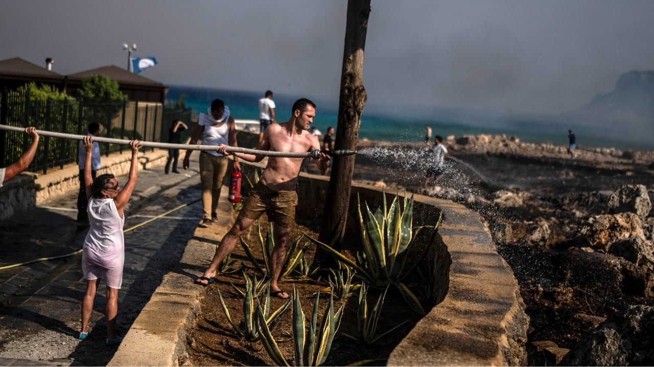 Near the seaside resort of Lindos, AP reporters saw hotel employees and guests, joined by local residents and firefighters, use fire extinguishers, towels and buckets of pool water to put out a small brush fire that broke out in the area. Evacuations were also ordered overnight on the western island of Corfu, where more than 2,000 people were moved to safety by land and sea, as well as on the island of Evia and in a mountainous area in the southern Peloponnese region. (Source: AP)