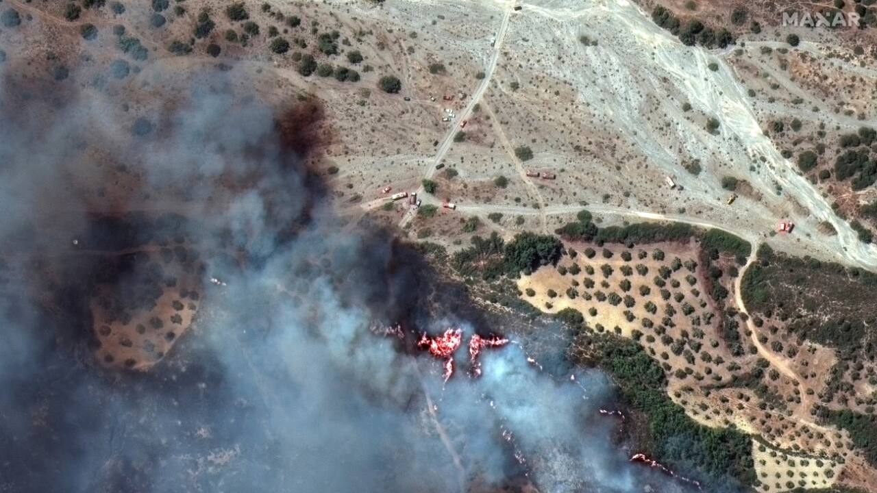 Greece is using an EU satellite service to estimate the damage caused by the fire and to target resources. Photographs published online by the service showed a brown hourglass-shaped burn scar across the middle of the island. (Source: AP)