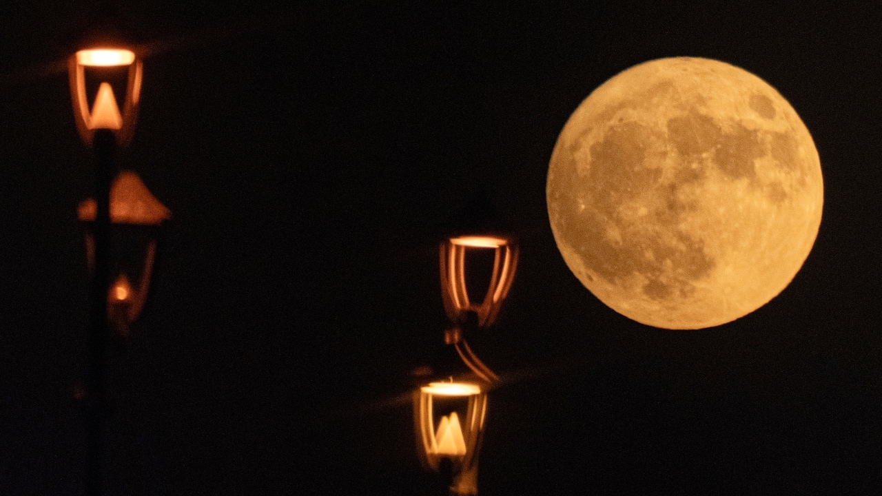 The supermoon rises over the Al-Ahrar Bridge, in central Baghdad, Iraq. The moon appears slightly brighter and bigger than normal because it is closer than usual, just 357,530 kilometers (222,159 miles) away, thus the supermoon label. (Image: AP)
