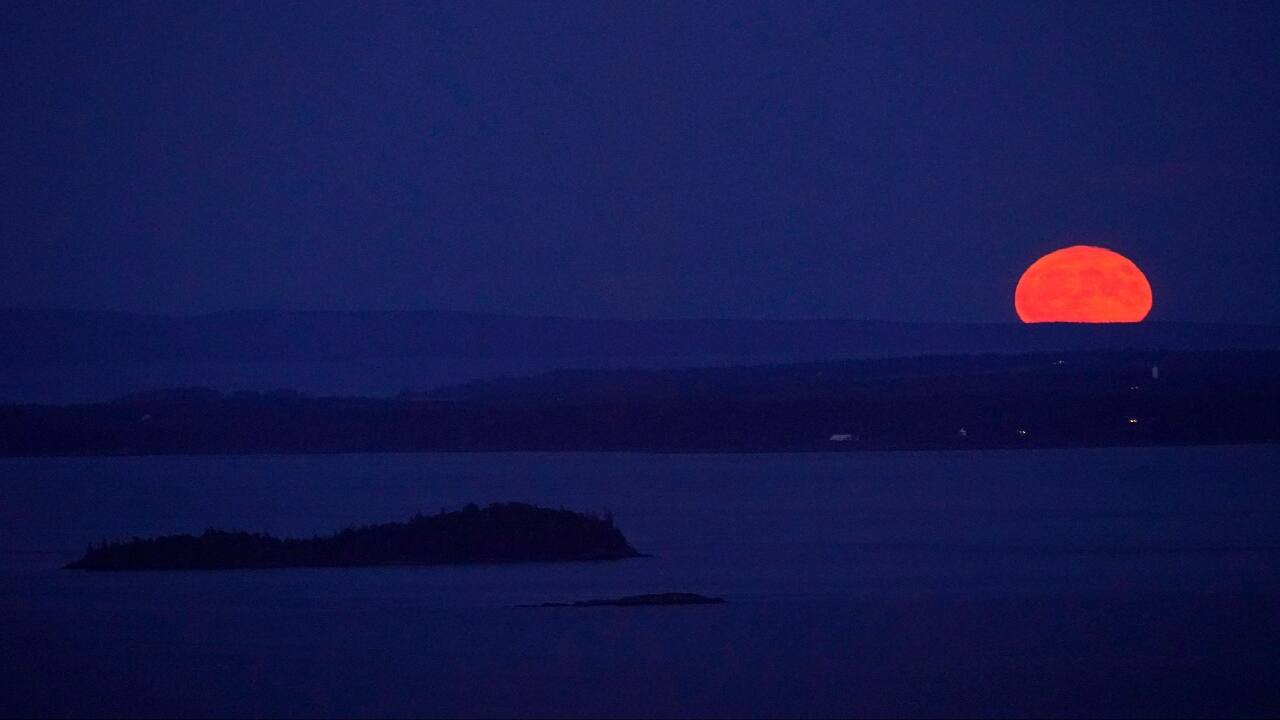 The supermoon rises behind Isle Au Haut in the distance, and North Haven Island, middle ground. (Image: AP)