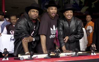 Hip-hop pioneers RUN-DMC create handprints in cement in February 2002, as they are inducted into Hollywood's RockWalk. The company had noticed an unusual spike in sales of its Superstar shoes in the Northeast in 1986, it didn't attribute the same to Run-D.M.C. and their hit “My Adidas.” However, when company officials saw the group ask fans to show off their Adidas and thousands removed their shoes and waved them in the air at a Madison Square Garden performance, they were sold. The rap group was signed in a $1-million deal that gave birth to their exclusive shoe line in 1988. (AP Photo)