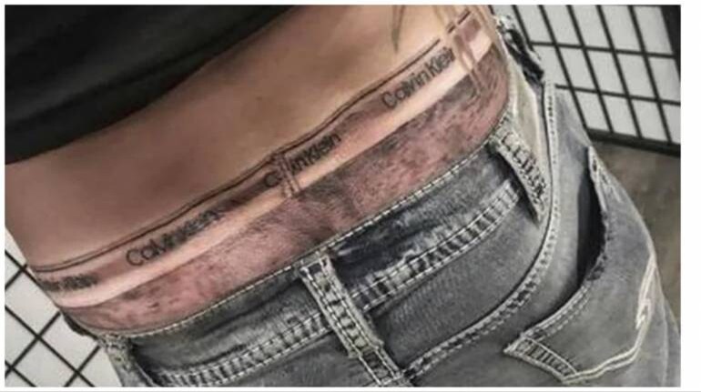 Man gets Calvin Klein underwear tattoo on hips to look like he's