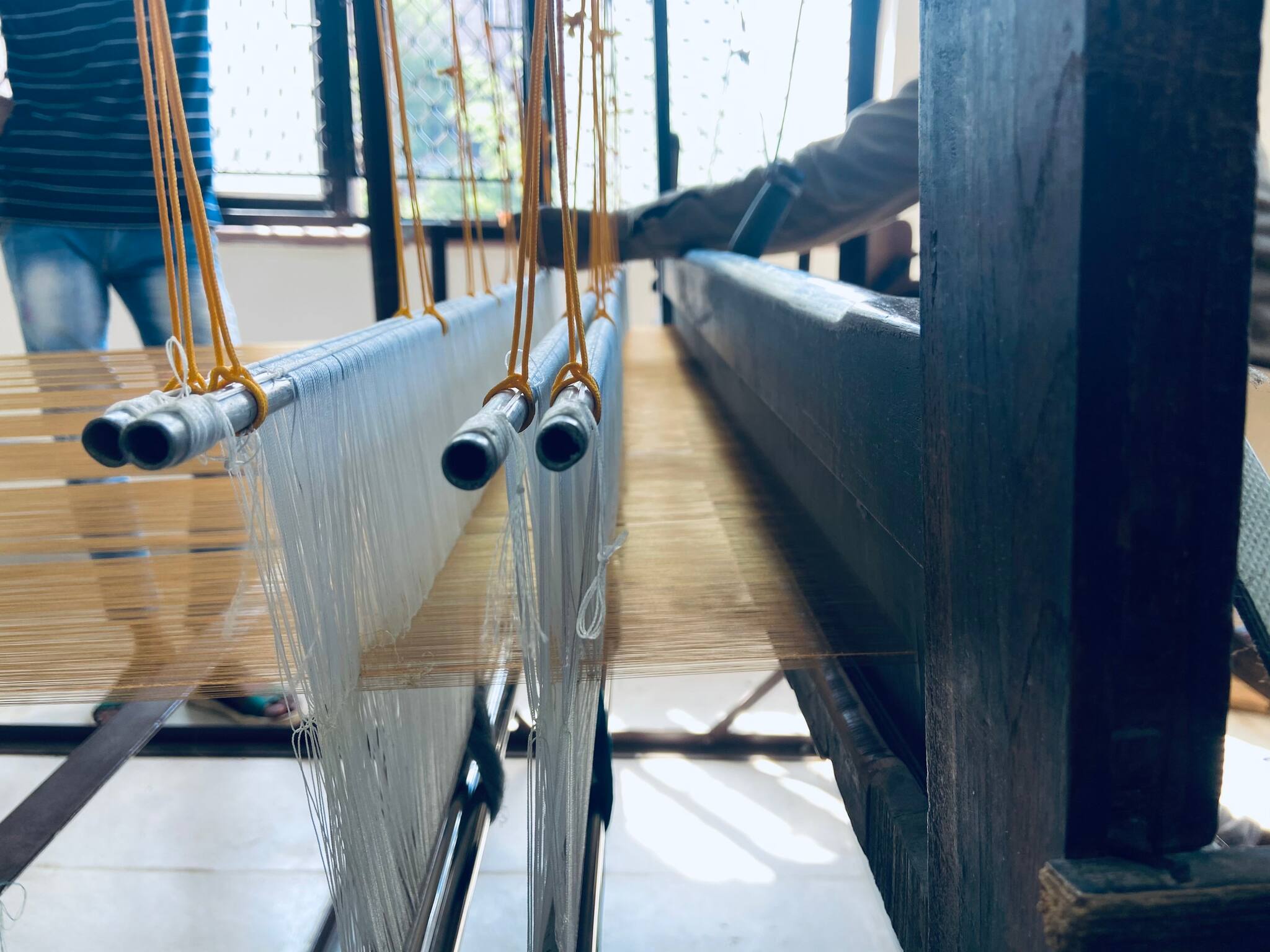 Weavers weave the yarn on a loom from scratch