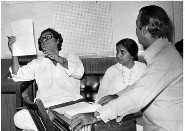 A vintage photo of Asha Bhosle at a playback session with singer Kishore Kumar (left).