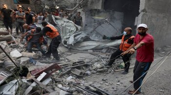 Rescuers search for victims or survivers under the rubble of a house destroyed in an Israeli strike on Rafah in the southern Gaza Strip on October 22. (Image: AFP)