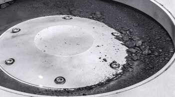 A view of the outside of the OSIRIS-REx sample collector. Sample material from asteroid Bennu can be seen on the middle right. The bulk of the sample is located inside. (Image courtesy: NASA)