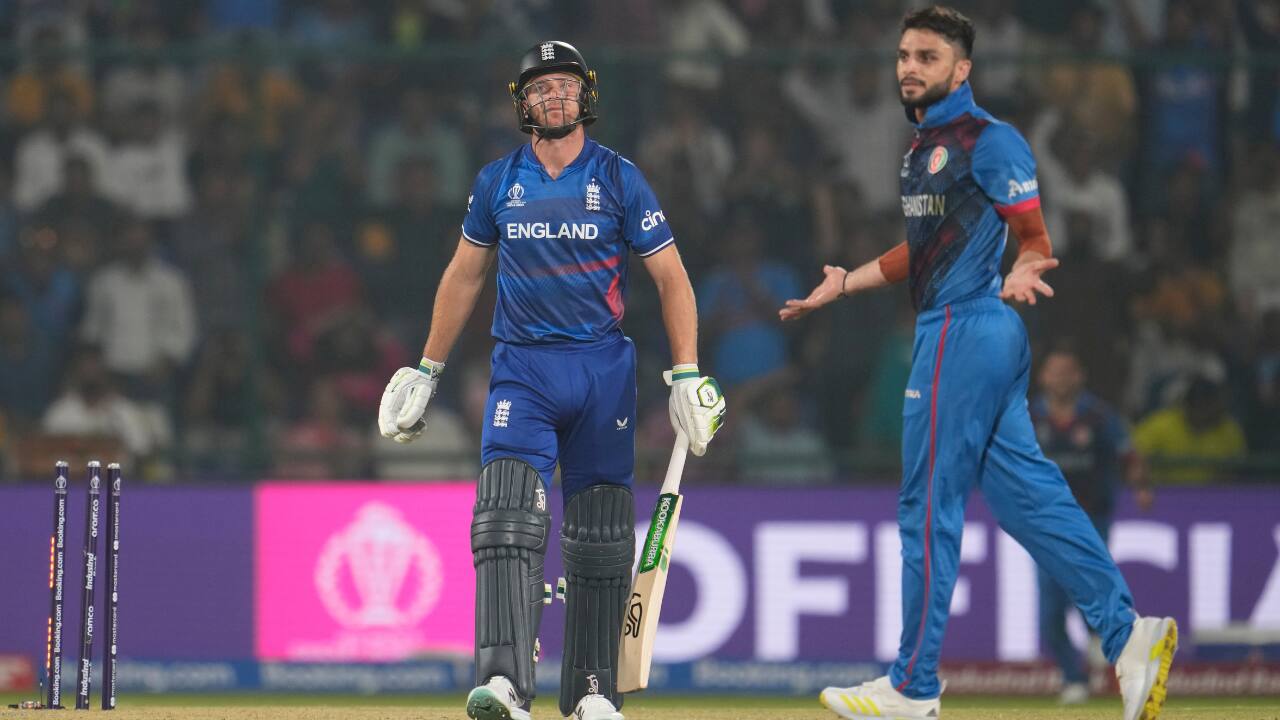 Afghanistan's Ikram Alikhil hits a six as England's captain Jos Buttler watches during the ICC Men's Cricket World Cup match between Afghanistan and England in New Delhi, India, on Sunday. (Image: AP)