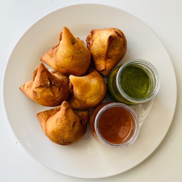 Samosa and chutney (Photo by Zi’s Food & Nature Art via Pexels)