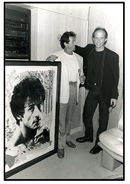Jim Evans presents painting to Sylvester Stallone. (Photo credit: Robert Knight, Jim Evans via Wikimedia Commons 4.0)