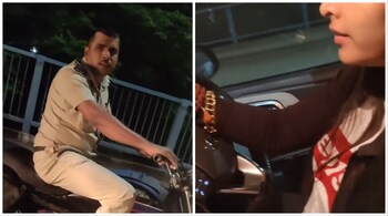 A viral video shows two women pursuing a cop who was riding a bike without a helmet. (Image: screengrab from video @gharkekalesh/X)