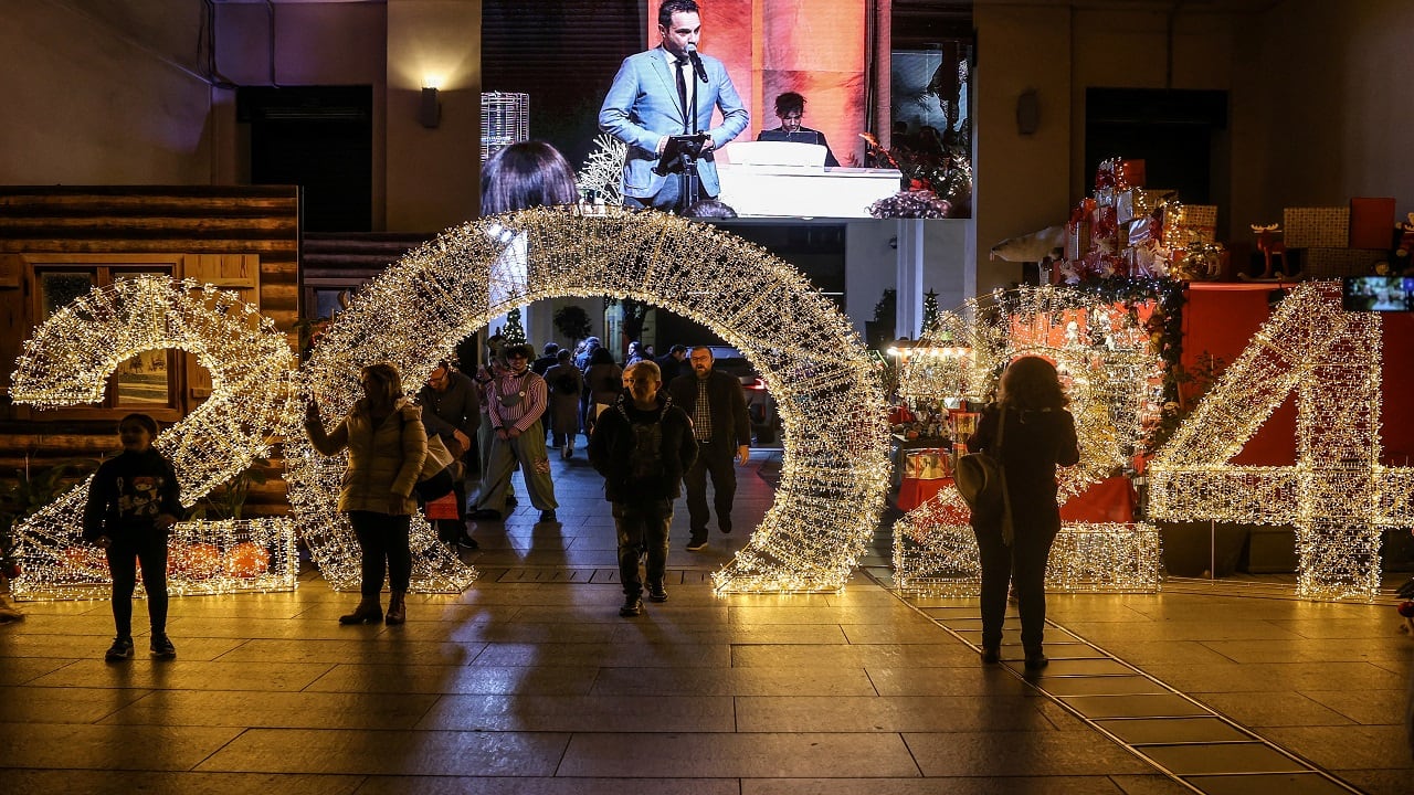 Athens: People walk past New Year's decorations, in a shopping arcade in the centre of the city, ahead of the New Year's Eve celebrations. (Image: Reuters)