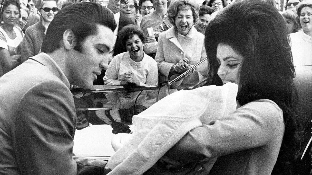 Elvis and Priscilla with newborn Lisa Marie, February 1968. (Photo via Wikimedia Commons)