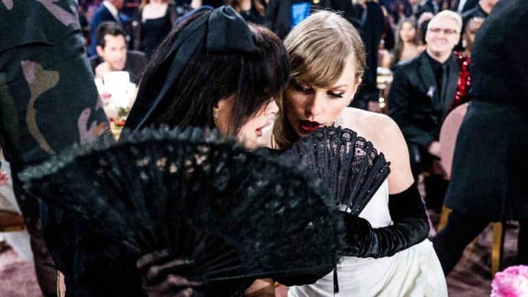 Lana Del Ray and Taylor Swift gossip at the Grammys. (Image via Recording Academy, CBS)