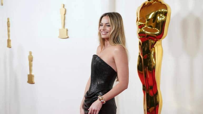 Margot Robbie, although controversially not nominated for &quot;Barbie,&quot; made a fashion statement in a black sequined Versace gown, exuding elegance and sophistication (Image: AP)