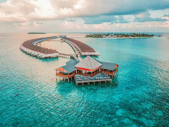 Try cocktails at sunset and late night dances on glass over water in Maldives. (Photo: Rayyu Maldives via Unsplash)
