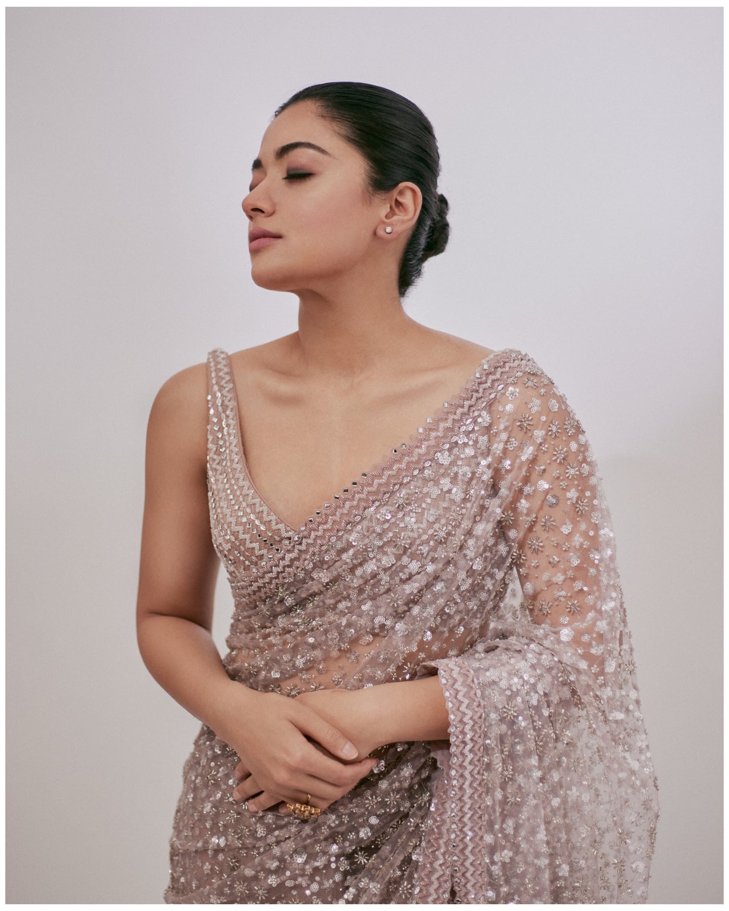 The Golden Girl Charm: Rashmika Mandanna nails the look with a saree doused with floral-sequin embellishments, golden crystals, and mirror work borders. A matching sleeveless blouse with similar patterns perfectly completes the look! Our hearts can't take how gorgeous she looks! (Image via Instagram)