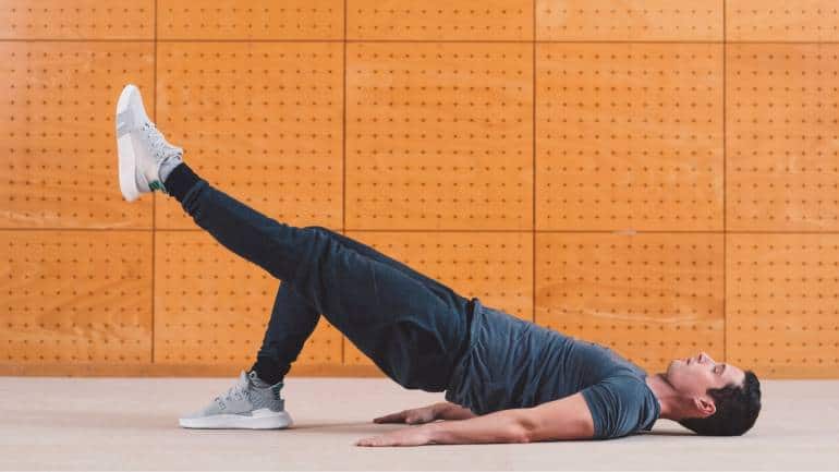 Single-Leg Glute Bridge • Lie down, lift right leg to the ceiling • Push through left foot, lift hips * Lower down slowly. Repeat 12–15 times per leg (Image: Canva)
