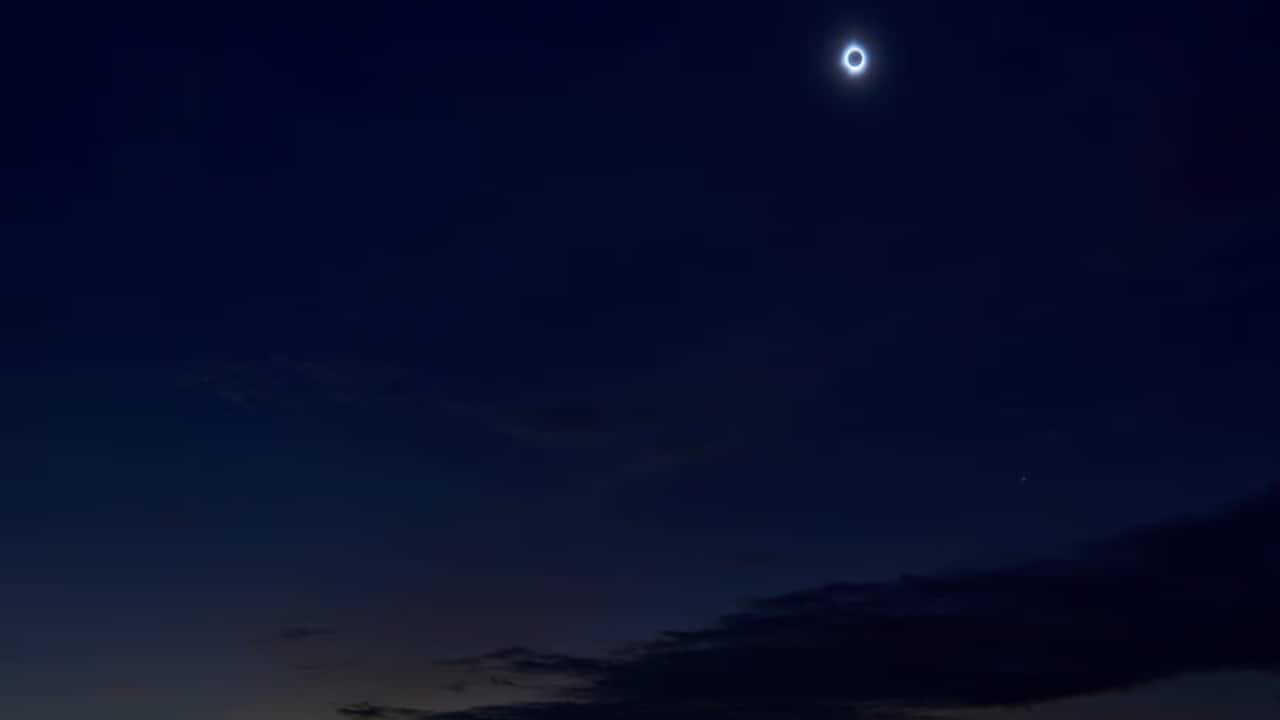 A total solar eclipse passes over with Eclipse Island seen in the background in Burgeo, Newfoundland, Canada. REUTERS/Greg Locke