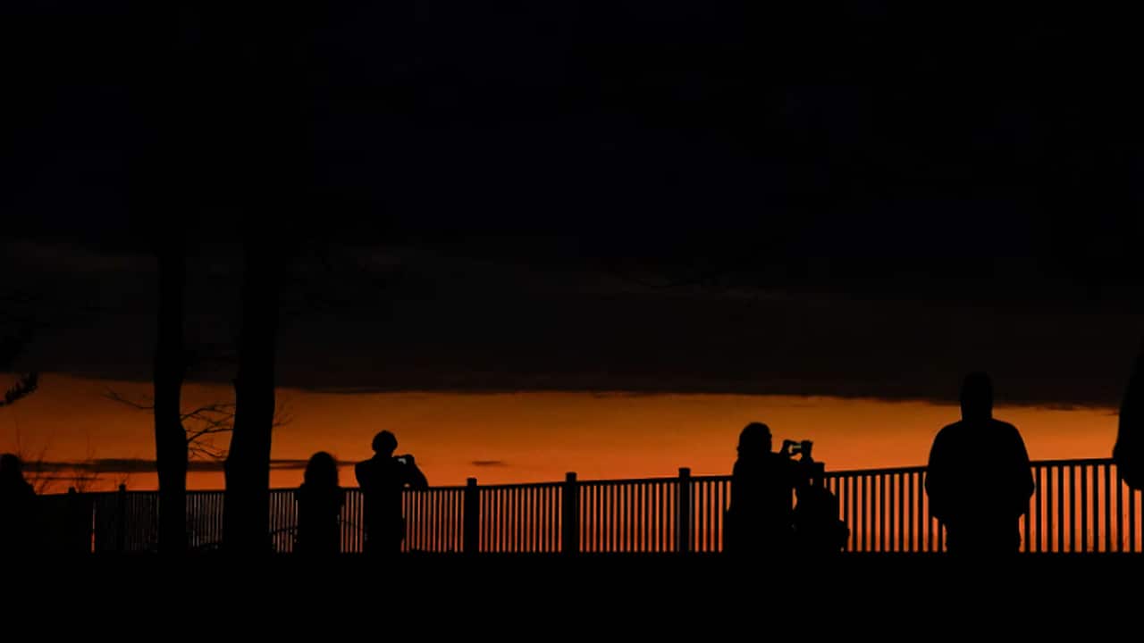 People look out towards Lake Erie and the horizon during a total solar eclipse under cloudy conditions seen from Dunkirk Lighthouse &amp; Veterans Park Museum in Dunkirk, New York. REUTERS/Elizabeth Frantz