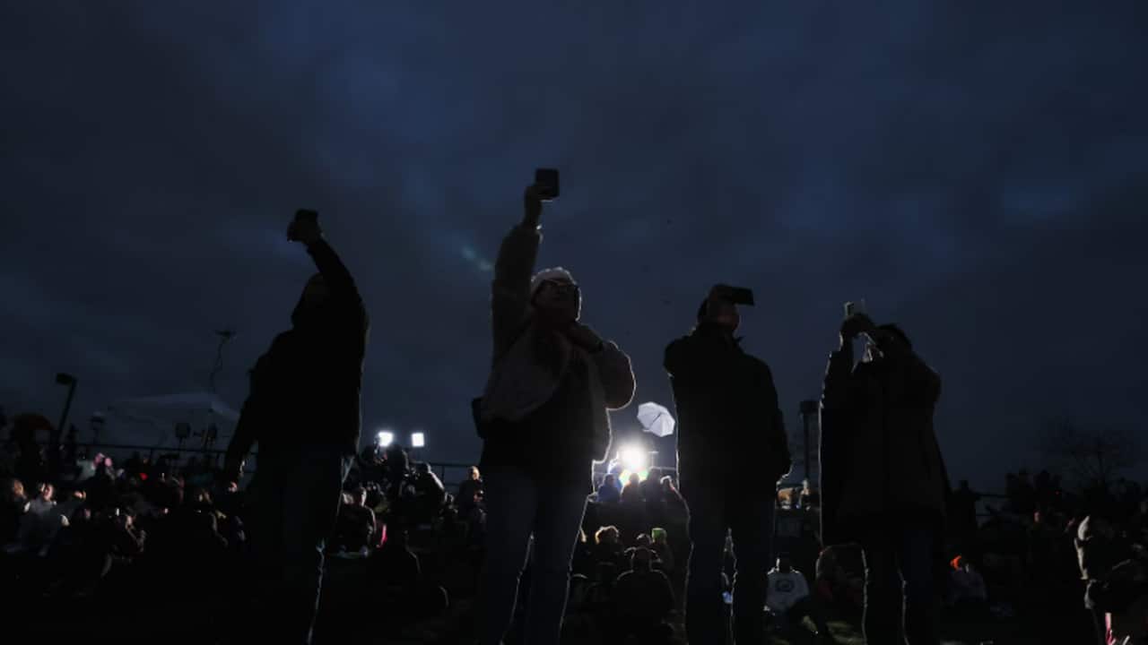 People view the total solar eclipse at Niagara Falls, New York. REUTERS/Brendan McDermid