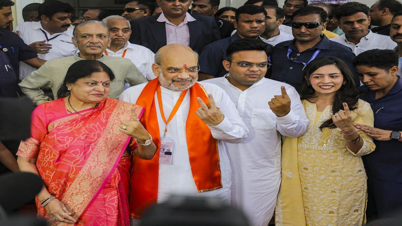 Union Home Minister Amit Shah, his family members show their inked fingers after casting their votes at a polling booth in Ahmedabad, Gujarat (PTI Photo)