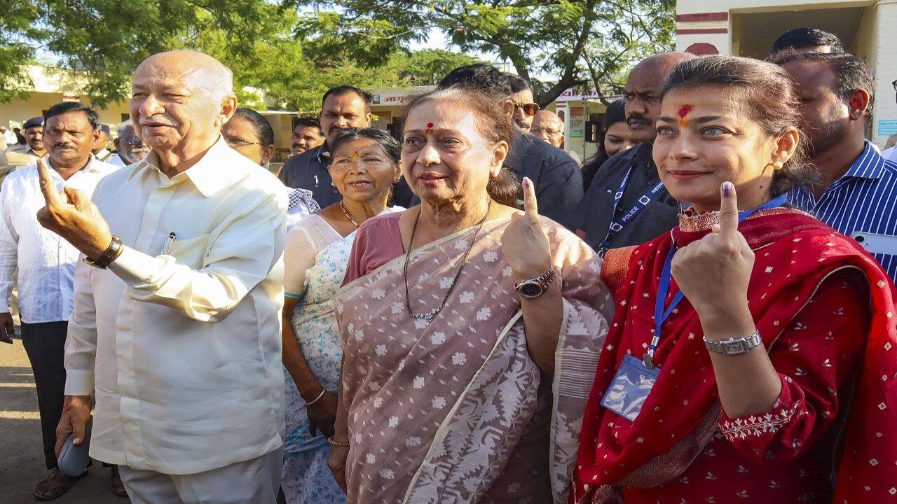 Karad: Senior Congress leader Sushilkumar Shinde with his family members shows his ink-marked fingers after casting vote during the third phase of Lok Sabha elections, in Karad, Tuesday, May 7, 2024. (PTI Photo)  (PTI05_07_2024_000251B)
